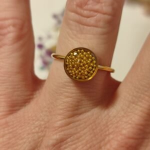Anillo ajustable de acero inoxidable con BOLITAS DORADAS encapsuladas en resina.