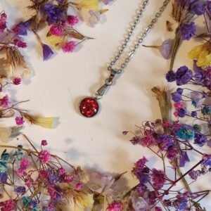 Colgante de acero inoxidable PURPURINA HOLOGRÁFICA encapsulada en resina.